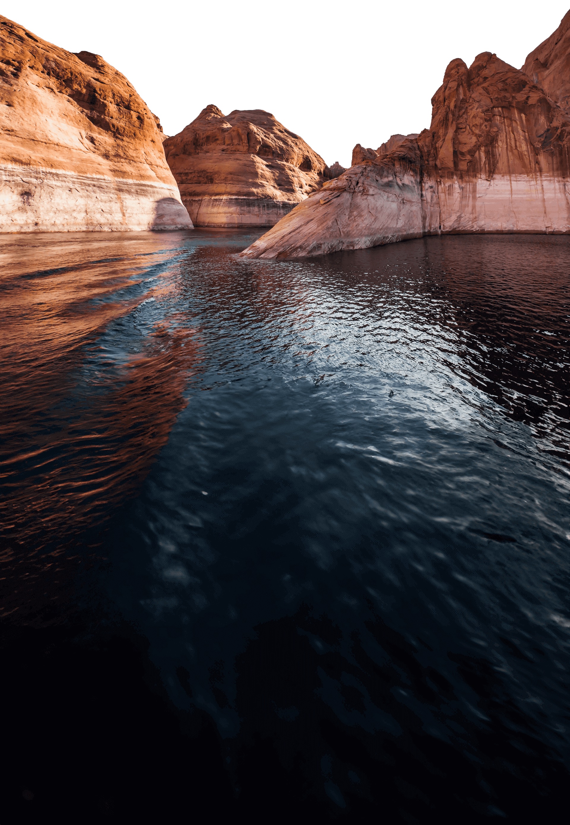 Lake Powell slot canyon — red sandstone walls rising above dark water